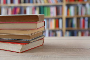 ahşap masa üzerine kitaplar