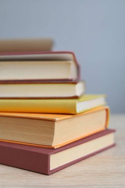 Beyaz arka planda ev şeklinde renkli bir yığın kitap var. Boşluğu kopyala