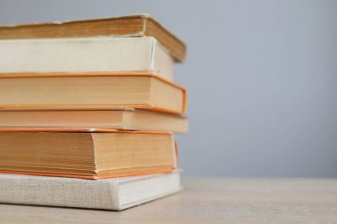 stack of books on table against white background.