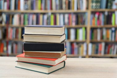 Tahta masadaki kitap yığını.