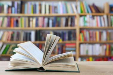 book on wooden table in library
