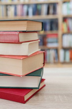 Kütüphanedeki masanın üzerinde kitap yığını