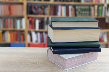 Kütüphanedeki masanın üzerinde kitap yığını