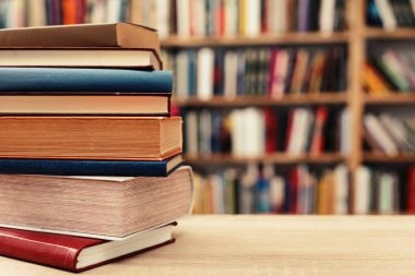 Tahta masadaki tahta kutuda yığınla kitap.