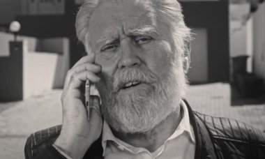 Parkta yaşlı bir adam biriyle konuşuyor.