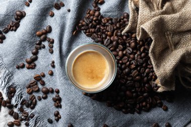 Koyu taştan arka planda bir fincan sıcak latte sanat kahvesi.