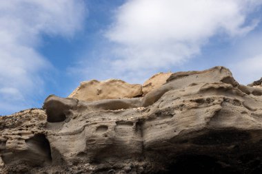 Coast of the Atlantic ocean, various rocks and stones. Different shapes and colors.. Sky with clouds in the winter. Playa de las Hermosas, Fuerteventura, Canary Islands, Spain