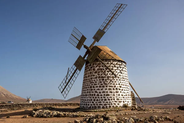 stock image Historical well preserved round shaped windmills, built on a hill. Blue sky. Molinos de Villaverde, Fuerteventura, Canary Islands, Spain.