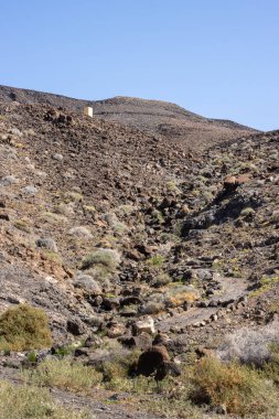 Kışın kuru yüzeyi olan yüksek kayalık dağlar. Parlak mavi gökyüzü. Parkın doğal Jandia, Fuerteventura, Kanarya Adaları, İspanya.