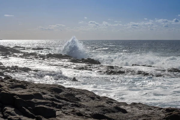 stock image Beach of the Atlantic ocean with a rocky coast. Calm water in the winter. Blue sky with light clouds. Aquas Verdes, Playa del Valle, Fuerteventura, Canary Islands, Spain.