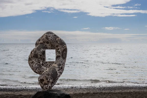 Stock image Unusual shape of a rock with a hole inside, to frame the photos of the Atlantic ocean. Beach in Tarajalejo, Fuerteventura, Canary Islands, Spain.