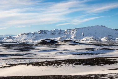 Gayzerlerin çok sık görüldüğü ve jeotermal aktivitelerin kar üzerindeki çözülmemiş çizgilerde de görülebildiği bölge. Kuzey-Merkez Bölgesi Myvatn, İzlanda 'da gün batımı.