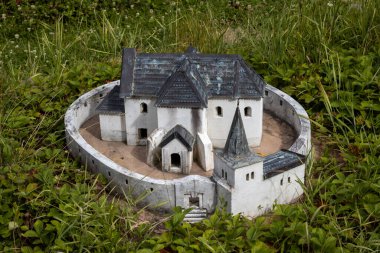 Exact miniature copy of the historical church of Saint Michael in Kocin - Lancar. Miniatures park where are important slovak sights. Podolie, Slovakia. clipart