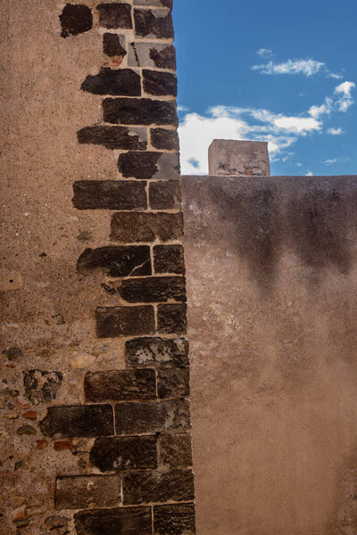 Детали архитектуры хорошо сохранившегося исторического здания замка Милаццо (Castello di Milazzo), построенного на холме с видом на Тиренское (Средиземное) море. Милаццо, Сицилия, Италия.