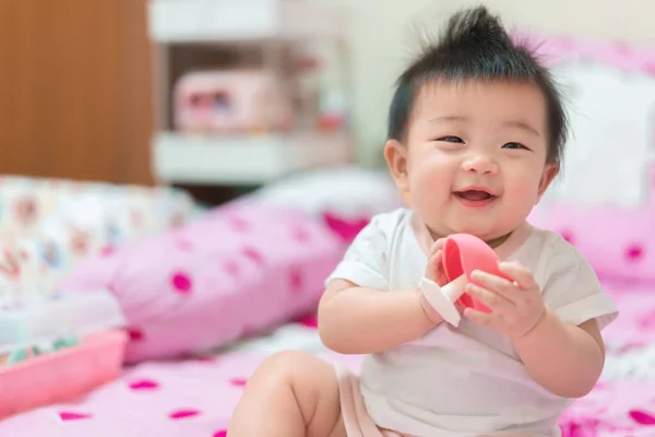 stock image Asian Infant girl biting teether, baby growing first tooth.