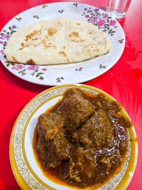 Bangladeş 'teki yerel bir restoranda Roti ile servis edilen bir tabak lezzetli baharatlı köri.