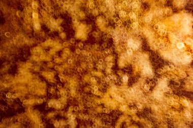 Işığın soyut dairesel bokeh arkaplanı. Parlak altın parlak ışık dokusu.