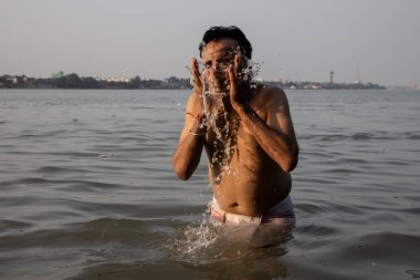Hintli bir adam sabahın erken saatlerinde Ganj nehrine dalıyor. Göğsü suya gömülü ve Tanrı 'ya dua ediyor..