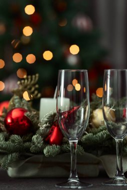 festive table on the background of a fir tree with a bokeh christmas and New Year's concept, interior details, selective focus