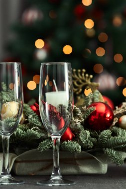 festive table on the background of a fir tree with a bokeh christmas and New Year's concept, interior details, selective focus