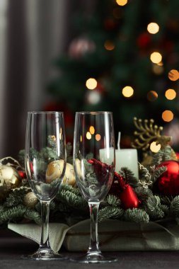 festive table on the background of a fir tree with a bokeh christmas and New Year's concept, interior details, selective focus