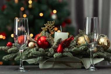 festive table on the background of a fir tree with a bokeh christmas and New Year's concept, interior details, selective focus