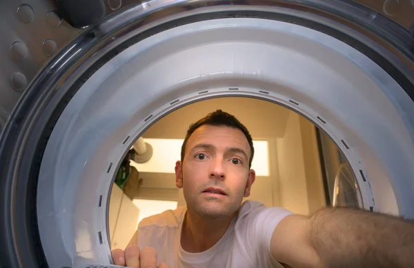 stock image Portrait of young male mechanic repairing washing machine at home