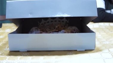 Genç bir kadının elleri, Roscon de Reyes 'in tipik İspanyolcasını göstermek için kutuyu açıyor. Epifani Günü geleneğinde İspanya 'da yenen panquemao sünger kekinden yapılan tipik tatlı. Yüksek kaliteli FullHD görüntüler