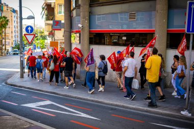 Alicante, Spain - September 26th 2024. Workers demonstrate in front of the employers' headquarters to demand a reduction of the working week to 37.5 hours. Trade unions CCOO and UGT. High quality photo clipart