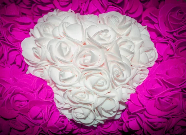 White Heart of Roses in the Embrace of Purple Flowers. Symbol of Eternal Love. Floral Background. Romantic Mood.