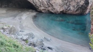 Mavi Okyanus 'un Üst Manzarası. Deniz Dalgaları Bir Havadan Bakış Amaçlı Güzel Bir Sahilde. Okyanus Dalgaları 'nın yukarıdan gelen boş bir taş kayaya çarpmasının güzel bir görüntüsü..