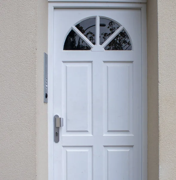 French Front Door. White Front door. Pastel Color Facades with a White Door.