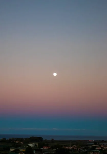 Beautiful Pink and Purple Full Moon Rise at Sunset. Early Morning Dawn Twilight with Moon.