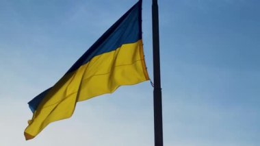 Ukraine Flag Flowing in the Wind. Ukrainian National Official Flag on Flagpole Waving in the Wind on Picturesque sky Background.