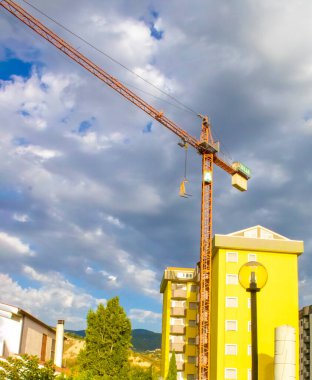 Crane and Construction Site Against the Blue Sky. Exterior Design of Modular Houses of Modern Architecture.