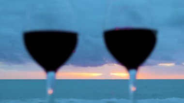 Two Glasses on the Ocean Beach. Glasses with Red Wine for a Romantic Date, Sea Water. Sunset Waves. Wine on the Beach at Sunset, Italy.