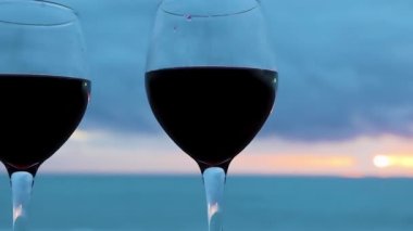 Two Glasses on the Ocean Beach. Glasses with Red Wine for a Romantic Date, Sea Water. Sunset Waves. Wine on the Beach at Sunset, Italy.