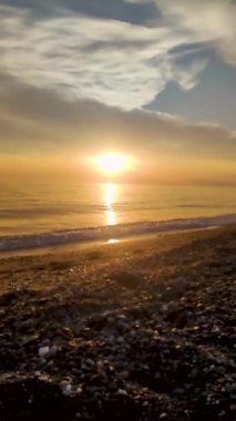 Sunset on the Horizon. Fantastic View of the Ocean, Sea. Beautiful Golden Sunset and Clouds. Natural Background.