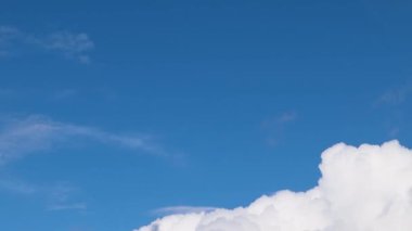 Fly Above the Clouds. Camera Over Cinematic White Thick Cloud in the Afternoon on a Clear Day. A Sea of Clouds to the Horizon. Amazing Natural Landscape with Blue Sky, 4K.