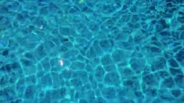 An Amazing View of the Swaying Blue Waters of the Pool with Shimmering Sinuous Lines Creating a Mesmerizing and Artistic Backdrop.