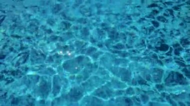 An Amazing View of the Swaying Blue Waters of the Pool with Shimmering Sinuous Lines Creating a Mesmerizing and Artistic Backdrop.