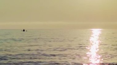 Fantastic Background on a Fishing boat in Sea Water Early in the Morning and a Beautiful Sunrise. Boat in the Sea Against Sunset. The Concept of Tranquility, Hobbies and Entertainment.