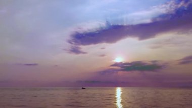 Fantastic Background on a Fishing boat in Sea Water Early in the Morning and a Beautiful Sunrise. Boat in the Sea Against Sunset. The Concept of Tranquility, Hobbies and Entertainment.