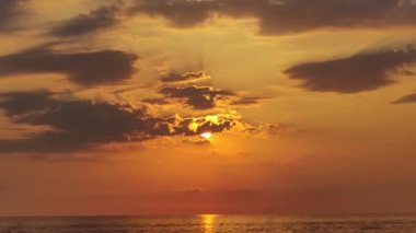 Sunset on the Horizon. Fantastic View of the Ocean, Sea. Beautiful Golden Sunset and Clouds. Natural Background.