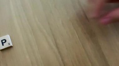 Peace Spell. The Hand of a Young Girl Lays out the Letters on a Light Background, Peace Text. Danger Concept. Protest Against Russian Invasion of Ukraine.