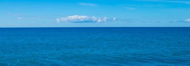 Beautiful Seascape Panorama. Composition of Nature. Paradise Beach. Exotic Water Landscape with Clouds on the Horizon. Natural Tropical Water Paradise. Vacation in Italy. Travel.