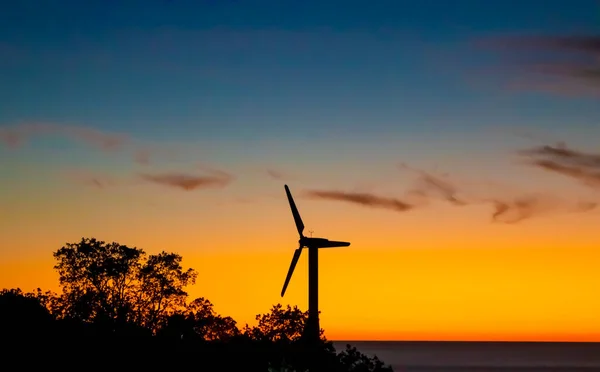 Wind Farm Silhouette. Energy Windmills Silhouette Against the Backdrop of a Fantastic Sunset. Conceptual Photo of Ecological Power.