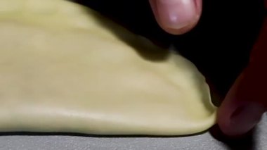 Men's Hands Wrap the Edges of a Cheburek or Dumpling. Dough for Pizza, Bread, Pies, Dumplings or Dumplings. Homemade Baking. Cook at Home.