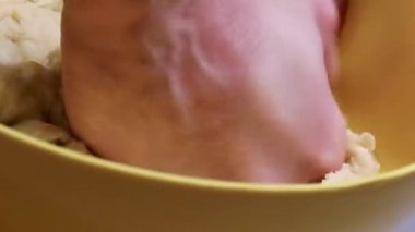 Male Hands are Preparing to Knead the Dough from Flour, Eggs, Milk and Salt for Cooking. Dough for Pizza, Bread, Pasties, Ddumplings or Dumplings.