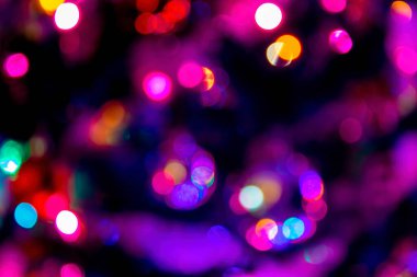 Background Blur. Bright Blurred Sparkles and Colorful Circles on a Dark Background.
